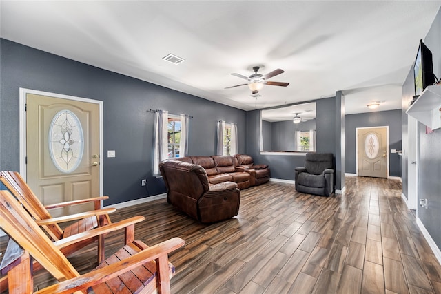 living room with dark wood-type flooring and ceiling fan