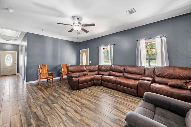 living room with ceiling fan and wood-type flooring