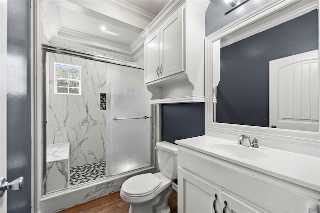 bathroom featuring wood-type flooring, toilet, crown molding, a shower with door, and large vanity