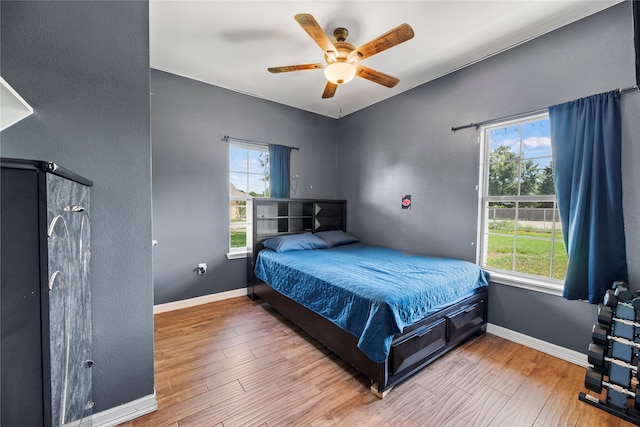 bedroom with ceiling fan and hardwood / wood-style floors