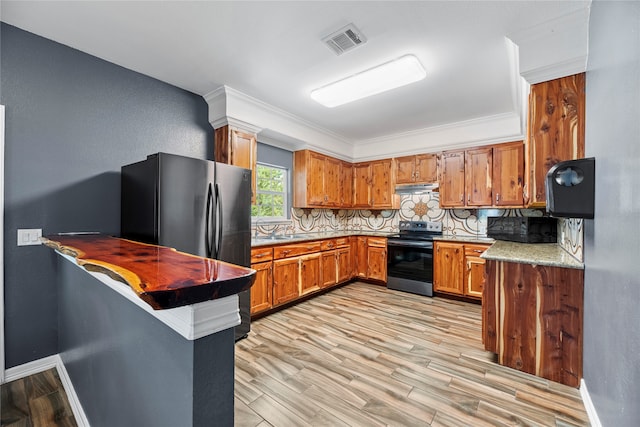 kitchen with light hardwood / wood-style floors, stainless steel fridge, range with electric cooktop, backsplash, and ornamental molding