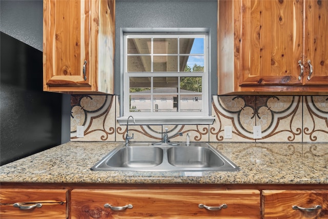 kitchen with light stone countertops and sink