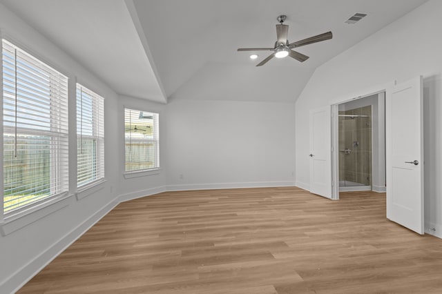 unfurnished bedroom featuring connected bathroom, light hardwood / wood-style floors, vaulted ceiling, and ceiling fan