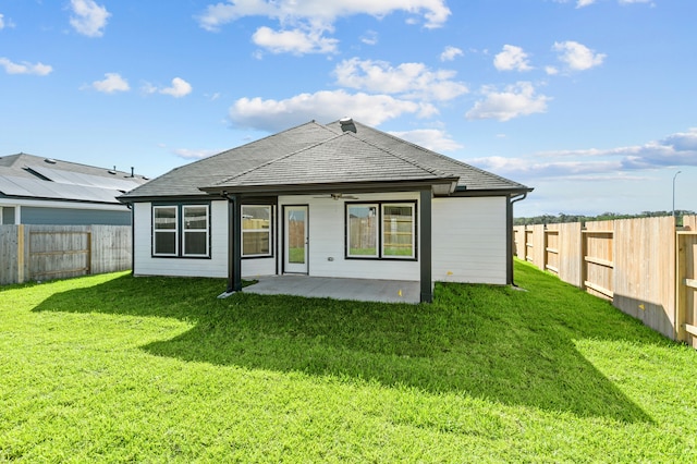 back of house with a patio and a yard