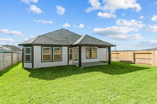 back of property with a patio area and a lawn