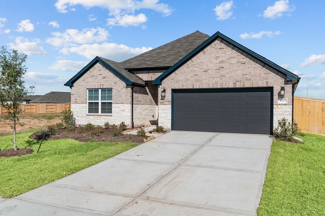 view of front facade featuring a front yard and a garage