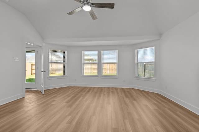 spare room featuring ceiling fan, lofted ceiling, and light hardwood / wood-style flooring