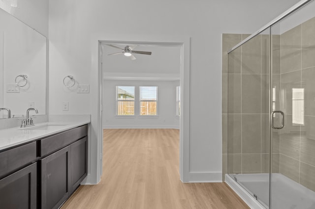 bathroom featuring vanity, ceiling fan, an enclosed shower, and hardwood / wood-style floors