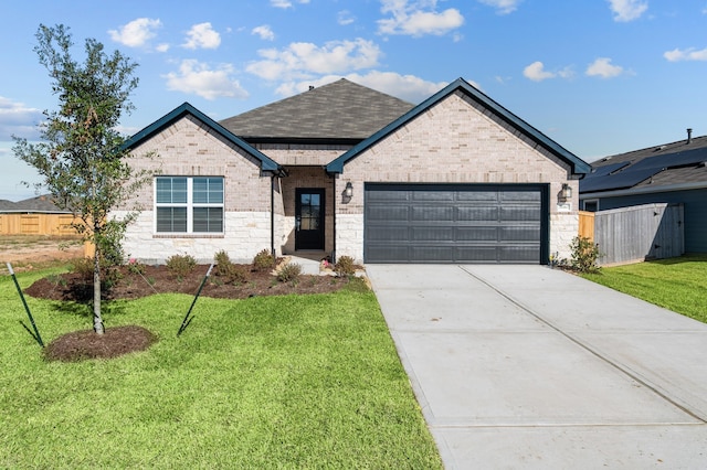 view of front of property featuring a front lawn and a garage