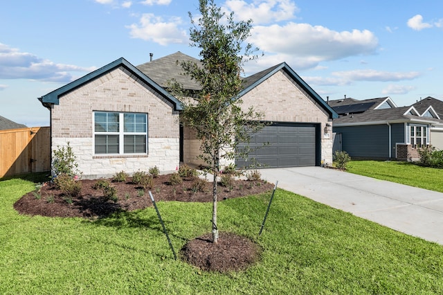 view of front of house featuring a front yard and a garage