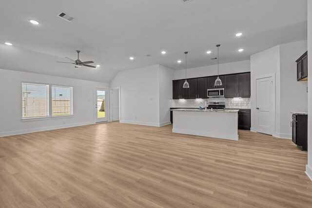 kitchen featuring ceiling fan, stainless steel appliances, vaulted ceiling, and light wood-type flooring