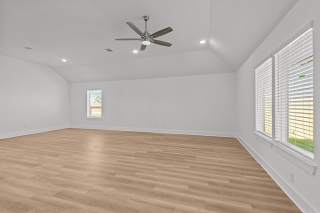 unfurnished room with ceiling fan, lofted ceiling, and light hardwood / wood-style flooring