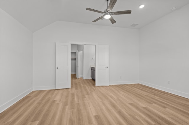 unfurnished bedroom featuring a closet, ceiling fan, lofted ceiling, and light hardwood / wood-style flooring