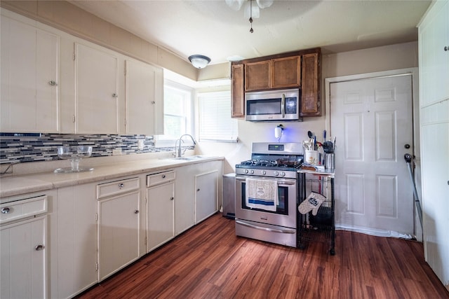 kitchen with white cabinets, dark hardwood / wood-style flooring, sink, and appliances with stainless steel finishes