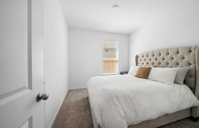 bedroom featuring dark colored carpet