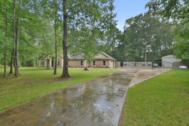 view of front of property with a garage, an outdoor structure, and a front lawn