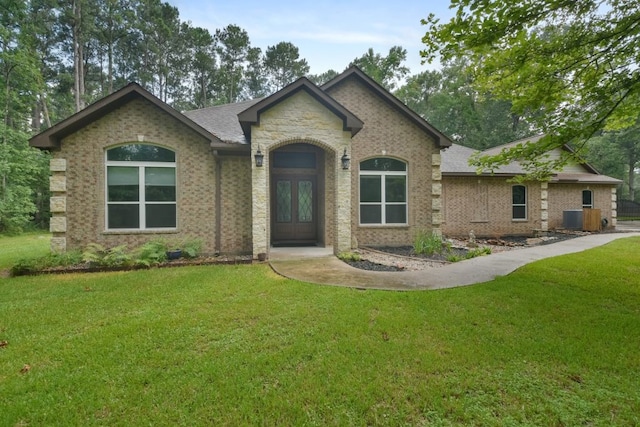 french country inspired facade featuring a front yard