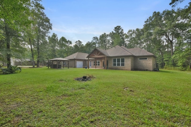 rear view of property featuring a lawn