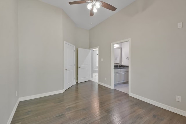 interior space with high vaulted ceiling, ensuite bathroom, dark hardwood / wood-style flooring, and ceiling fan