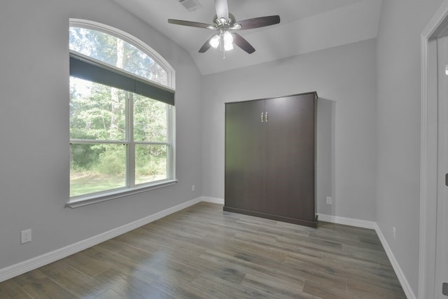 unfurnished bedroom with wood-type flooring, ceiling fan, and lofted ceiling