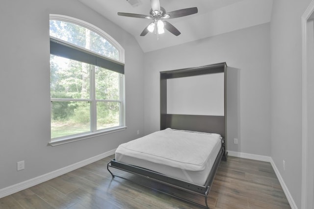 bedroom with ceiling fan, dark hardwood / wood-style flooring, and lofted ceiling