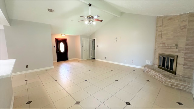 unfurnished living room featuring beam ceiling, a fireplace, light tile patterned floors, and ceiling fan