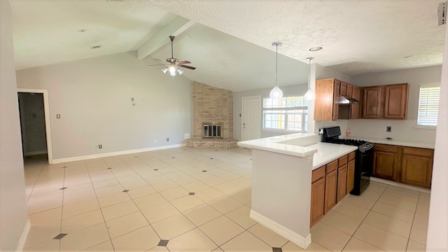 kitchen with a healthy amount of sunlight, gas stove, lofted ceiling with beams, and a brick fireplace