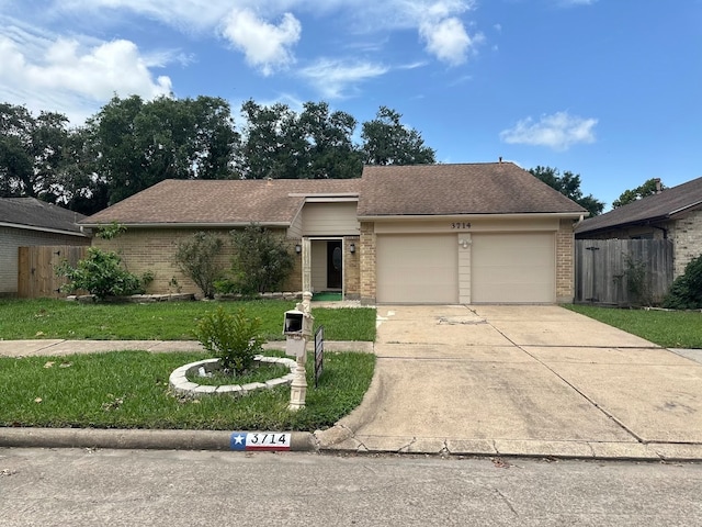 single story home featuring a garage and a front yard