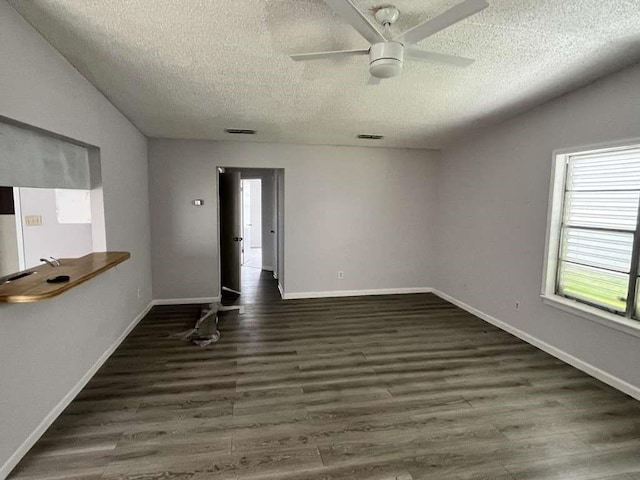 7206 Elwood Ct Unit A4, Corpus Christi, TX 78413 - empty room featuring a textured ceiling, a ceiling fan, wood finished floors, and baseboards