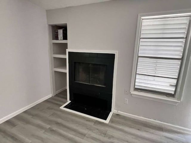 unfurnished living room featuring wood-type flooring