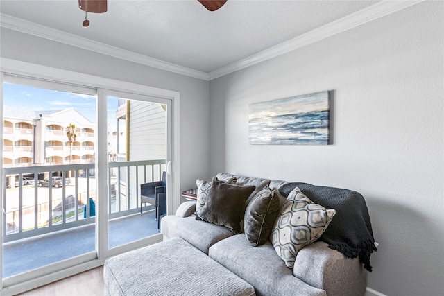 living room with ceiling fan, crown molding, and light wood-type flooring