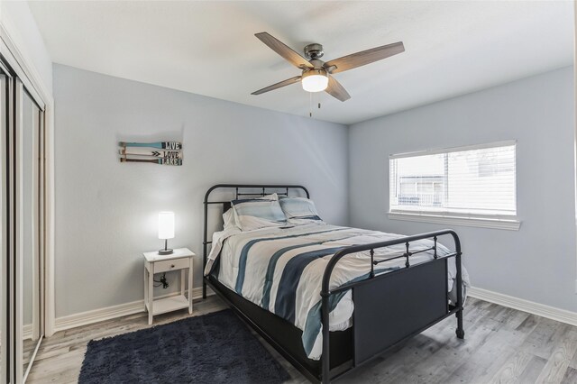 bedroom with wood-type flooring, a closet, and ceiling fan