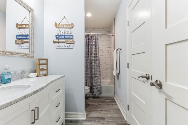 full bathroom featuring hardwood / wood-style floors, oversized vanity, toilet, and shower / tub combo