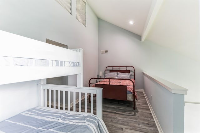 bedroom featuring dark hardwood / wood-style flooring and lofted ceiling