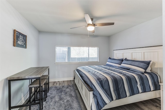 bedroom with ceiling fan, dark wood-style flooring, and baseboards