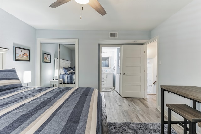 bedroom with ceiling fan, a closet, hardwood / wood-style floors, and ensuite bath