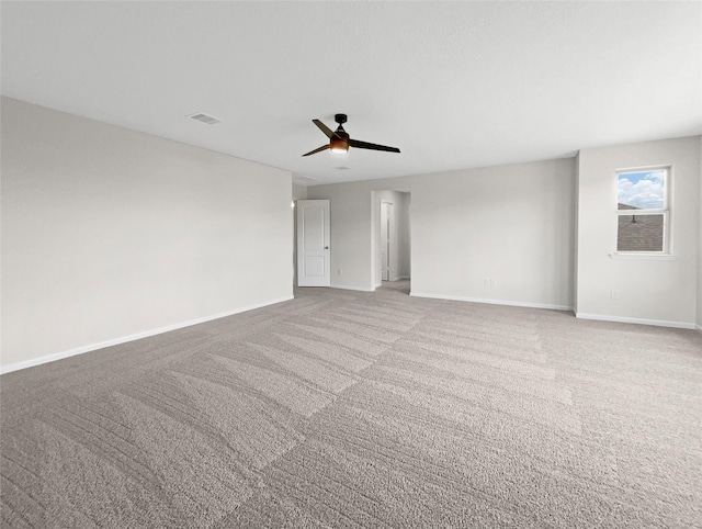 carpeted spare room featuring ceiling fan