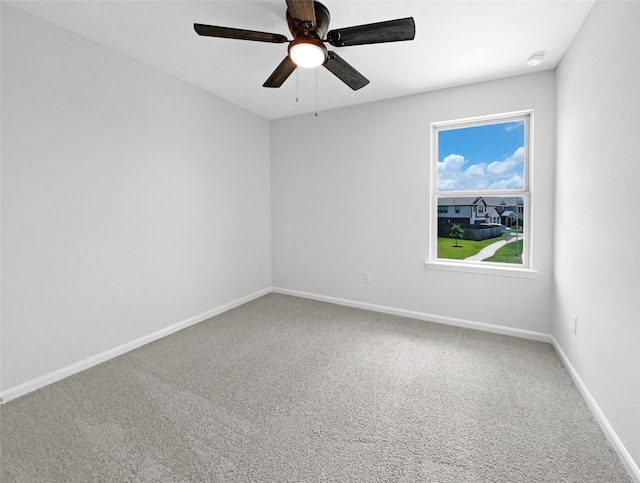 empty room with ceiling fan and carpet