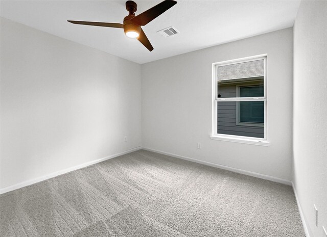 spare room with carpet and ceiling fan