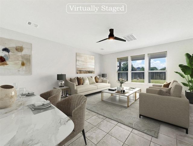 living room featuring light tile patterned floors and ceiling fan