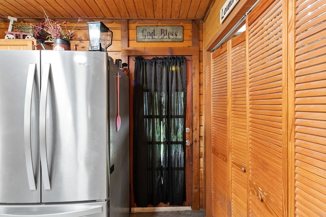 interior space with stainless steel fridge and wood ceiling