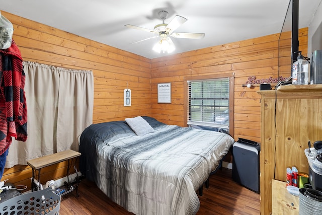 bedroom featuring dark wood-type flooring, ceiling fan, and wood walls