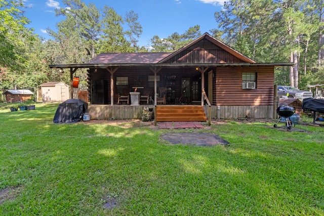 view of front of property with a front lawn and a storage shed