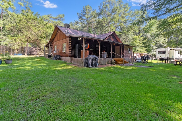 rear view of house featuring a lawn