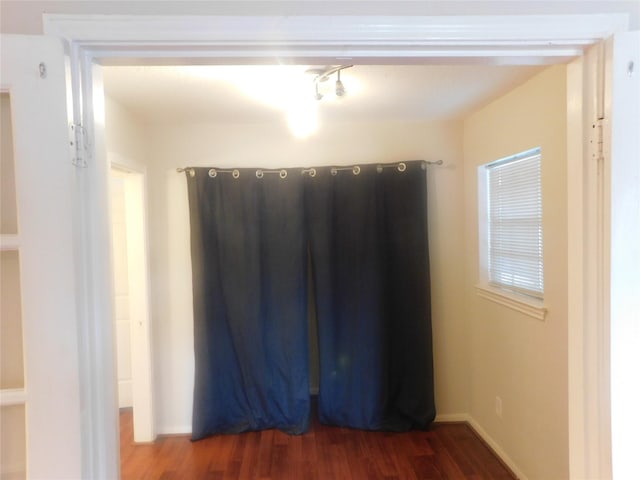 unfurnished room featuring dark wood-type flooring