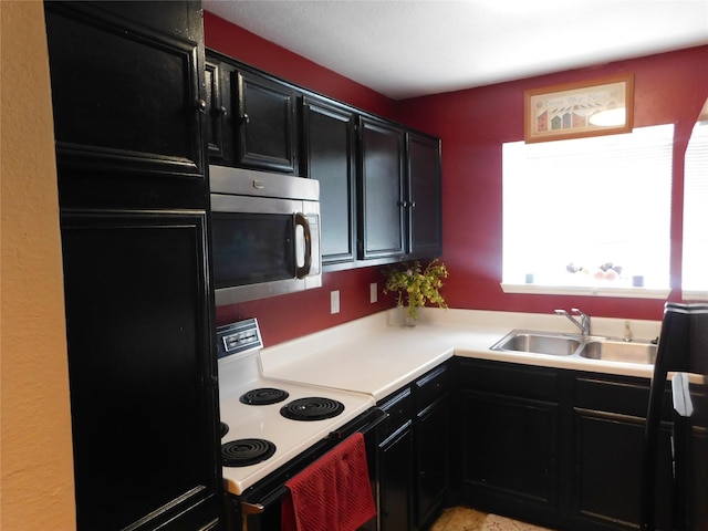 kitchen with sink and electric range