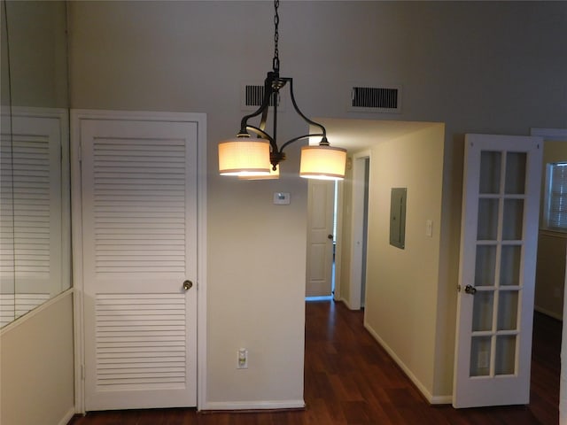 hallway with dark wood-type flooring and electric panel