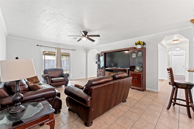 tiled living room with a textured ceiling, ceiling fan, and ornamental molding