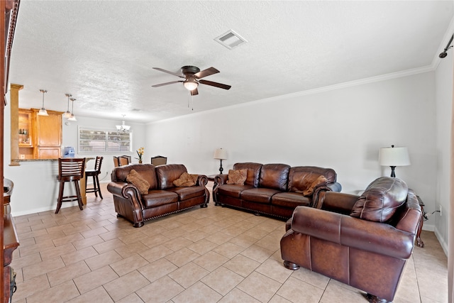 tiled living room with ceiling fan with notable chandelier, a textured ceiling, and ornamental molding