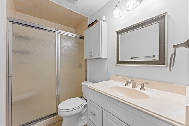 bathroom featuring tile patterned floors, toilet, vanity, and an enclosed shower